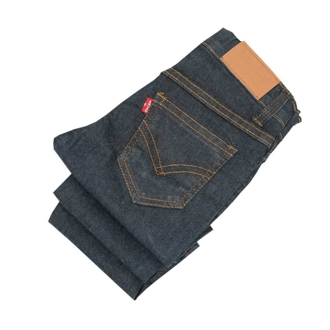 Folded pair of blue jeans with a  brown patch on a white background Jet Black Slim Fit Jeans for Kids | SHAH ROBE